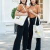 Đồng phục công ty màu vàng đồng - TT108, hai nữ khoác vai