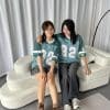 Áo lớp xanh Kick Off năng động AL404, hai nữ ngồi cạnh nhau