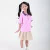 Đồng phục mầm non màu hồng đào phối quần váy sữa - MN104, bé gái đứng thẳng